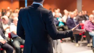 Man giving a lecture to a rapt audience.