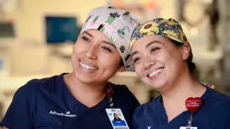 Two AdventHealth nurses smiling together