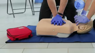 Two people in CPR training.