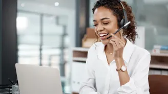Female Professional using a laptop and headset