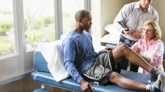A Sports Medicine Patient is Seen by a Physician While a Resident Takes Notes