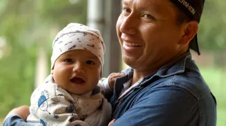 a man holding a baby