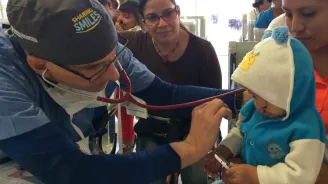 A doctor examines a child