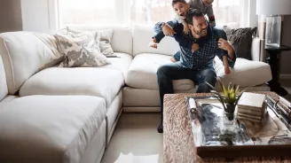 father-playing-with-his-two-sons-indoors