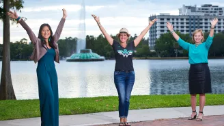 Three female cancer survivors in front of Lake Eola