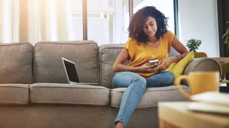 Woman reading phone on couch