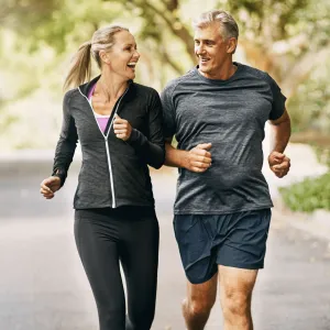 A man and a woman running on an incline