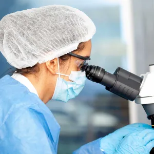 A histopathologist using a microscope