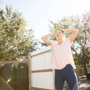 Woman Relaxing with Tires in Background