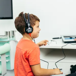 A boy getting a hearing test from a doctor.