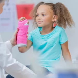 Little girl with a cast on her wrist