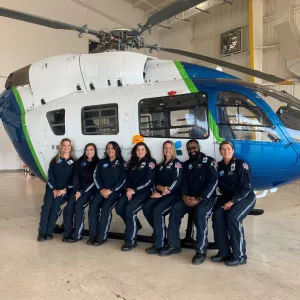 AdventHealth flight nurses and respiratory therapists gather for the unveiling of the hospital system's second rescue helicopter and new hangar at the Orlando Executive Airport.