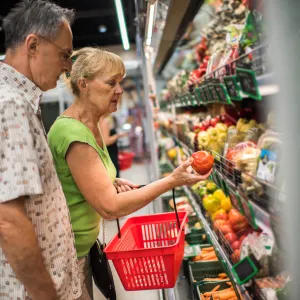 Mature couple buys vegetables