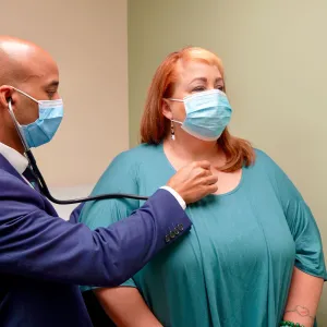 Post-COVID Clinic lead physician, Dwayne Gordon, M.D., sees a long COVID-19 patient at the clinic.