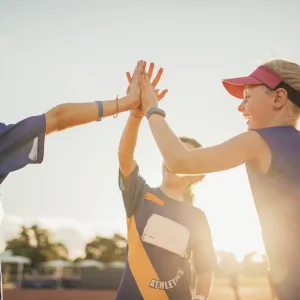 Young athletes high five after a good practice.