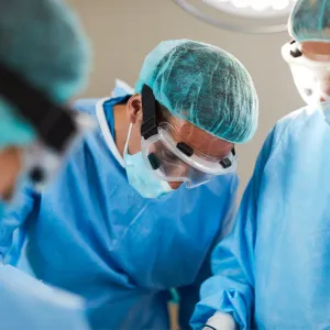 Dr. Tran with a surgical team in the operating room.