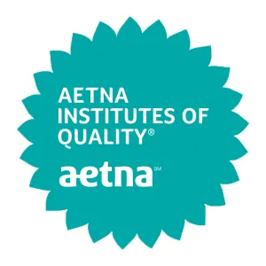 Aetna's circular turquoise badge with sunflower frills around it