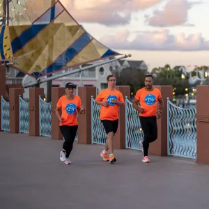 Chris Nikic Running with his team.