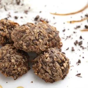 Five coconut mound cookies on a white surface