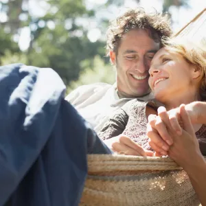 A romantic couple enjoying their time together on a hammock