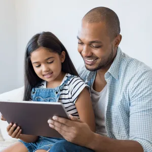 Dad and daughter reading tablet