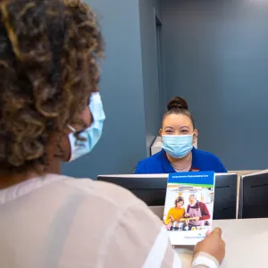 Front desk team member of AdventHealth Digestive Health Institute talking with patient.