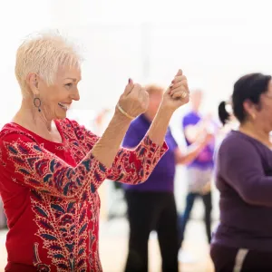 A group of older adults taking a dancing class.