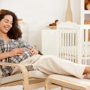 An expected mother resting in her baby room