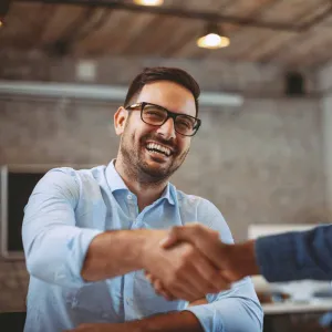 A man gives a handshake to the interviewer at a job interview