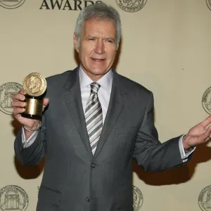 Alex Trebek getting a picture taken with the Peabody Award