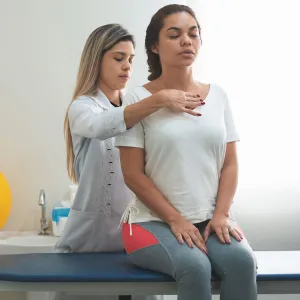 A doctor examines a patient's spine.