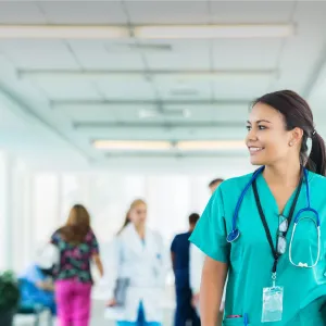 Female health care professional walking down hospital hallway