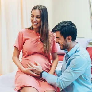 A young woman and man at the doctor for a pregnancy check-up