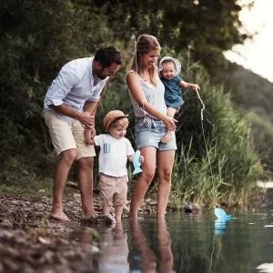 A family standing by the water.