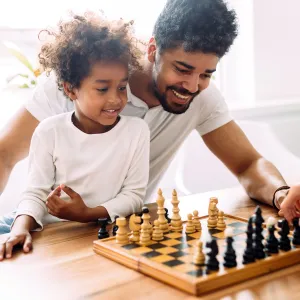 A family playing chess together. 