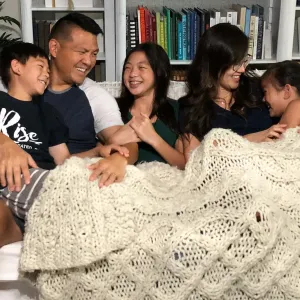 Family laughing on couch