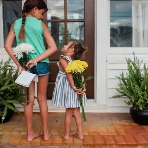 Two girls holding gifts