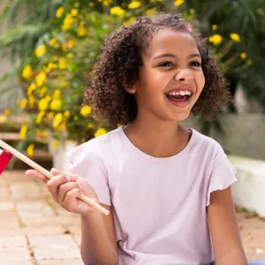 A young girl waves an American flag.