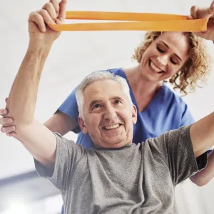 An older man receives physical therapy. 