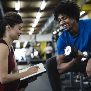 A man exercising with a personal trainer.