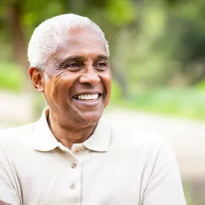 A man smiling outside. 