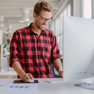 A man using a standing desk while working