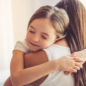 Young child embracing her mother