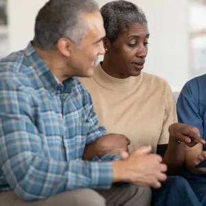 An older couple reviews their test results with their doctor.