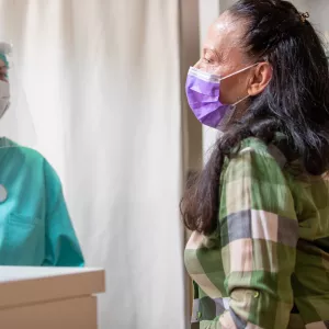 A woman visiting her provider for a flu shot. 