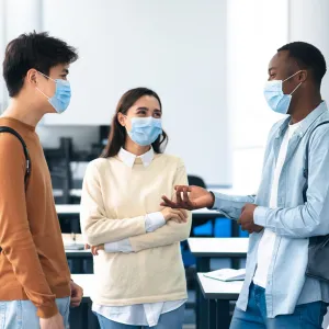 A group of students talking in their classroom