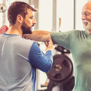 Trainer helping a person perform exercises