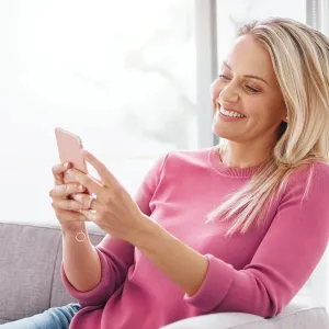 A woman on her phone, happily.