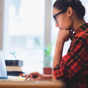 A woman focused on a task on her laptop