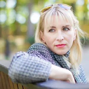 A woman sitting on a park bench as something catches her eye